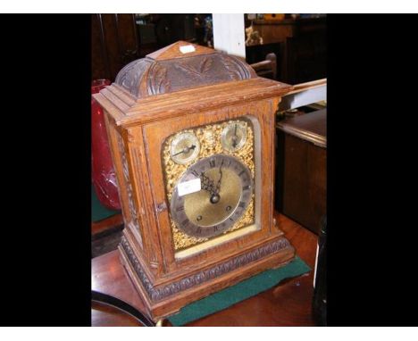 An oak cased chiming mantel clock - 42cms high