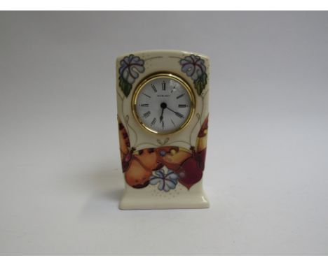 A Moorcroft Trellis pattern clock No: 18/300 with Certificate signed by John Moorcroft, 16cm tall, boxed