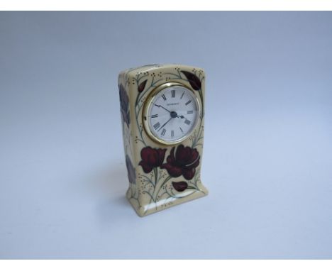 A Moorcroft Chocolate Cosmos pattern clock, designed by Rachel Bishop, 16cm tall, boxed 