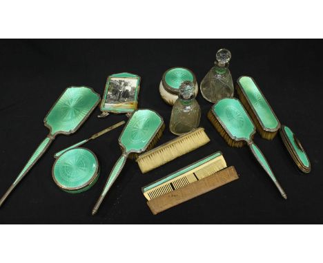 A large Swiss silver and green enamel dressing table set, with engine turned decoration, comprising two scent bottles, a bowl