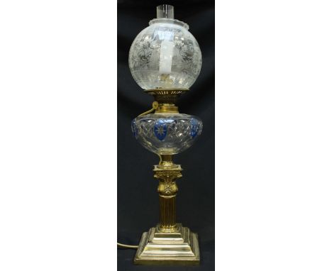 A brass Corinthian column oil lamp converted to electricity, with cut glass bowl, etched shade and supported on a stepped bas