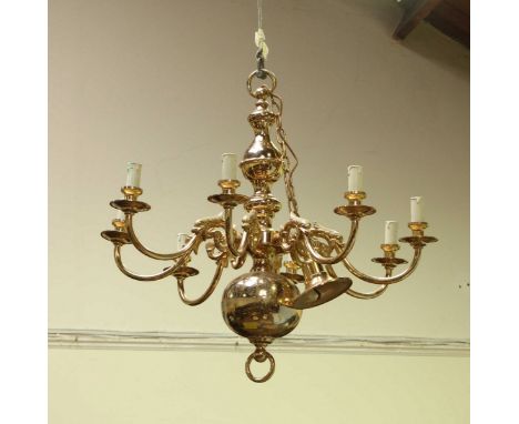 A large eight light brass handing chandelier, with bulbous globular base