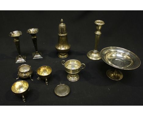 A small collection of silver items including a tazza, a sugar sifter, a pair of dolphin salts, silver cup, pair of spill vase