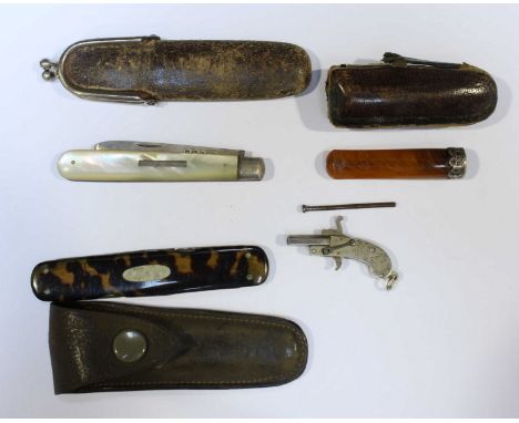 An early 20th century miniature silvered pistol, together with a silver bladed and mother of pearl fruit knife, a penknife an