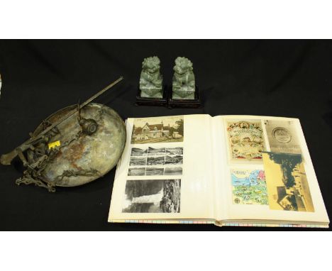 An album containing a small quantity of Edwardian and later postcards, together with a pair of Soapstone-carved Chinese templ