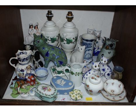 SECTION 8. A shelf of assorted ceramics including pottery cats, vases, and other ornaments