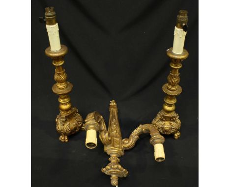 A pair of carved giltwood and gesso candlesticks, together with a two light wall sconce. (3)
