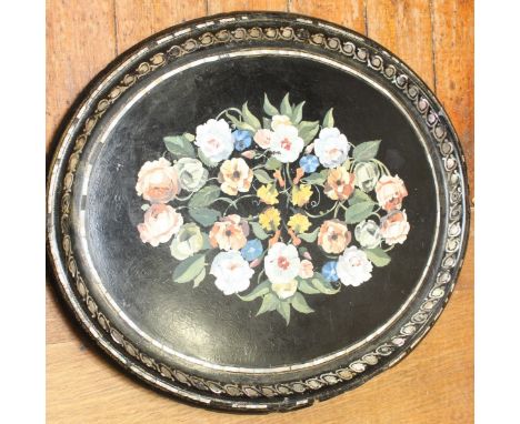 A large Victorian black lacquer painted papier mache tray, the centre painted with a large bouquet of flowers, the edge inlai