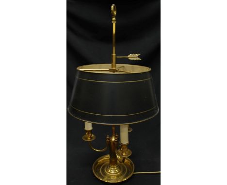 A brass three branch table light with toleware shade