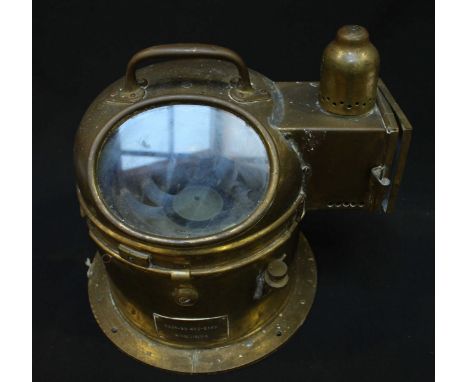 An early 20th century ships brass binnacle wet gimbal compass with integral spirit light and carrying handle. 25 cm high