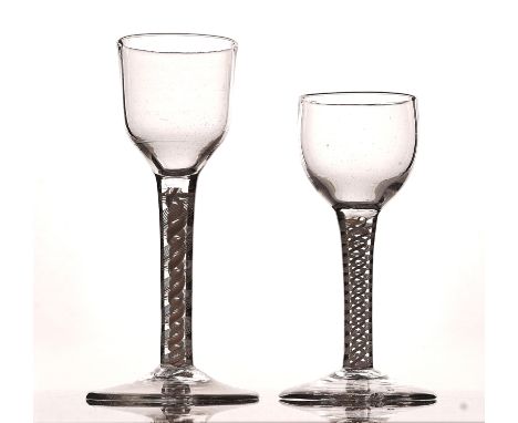 TWO OPAQUE TWIST WINE GLASSCirca 1765The first with ogee bowl, the second, smaller, with ovoid bowl, each raised on a double 