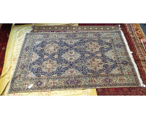 A NAIN PART SILK CARPET, PERSIANThe indigo floral field with rows of large medallions; an ivory complimentary medallion borde