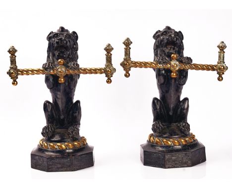 A PAIR OF VICTORIAN CAST IRON AND BRASS FIRE DOGS / TOOL RESTSMid-19th CenturyEach modelled as a rampant lion on an hexagonal