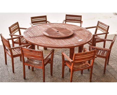 A LARGE CIRCULAR HARDWOOD GARDEN TABLE (9)180cm diameter, together with eight open armchairs, 61cm wide; 85cm high