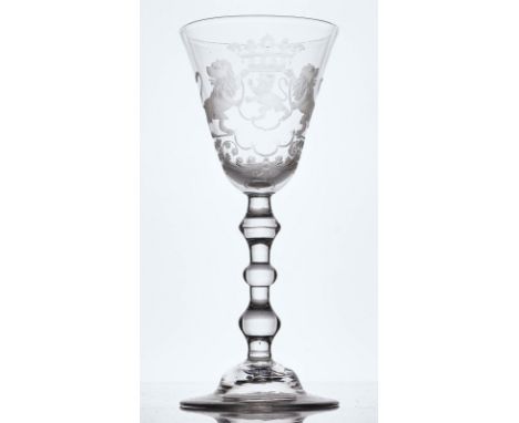 A DUTCH ENGRAVED ARMORIAL LIGHT BALUSTER WINE GLASSMid 18th centuryThe rounded funnel bowl engraved with the arms of the Neth