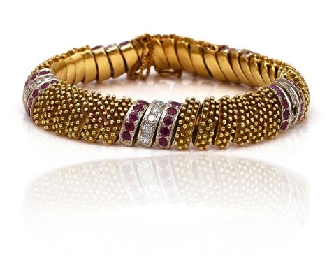 A GOLD, RUBY AND DIAMOND BRACELETDesigned as a row of curved beaded links, with ruby and diamond three row divisions at inter