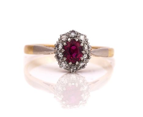 A GOLD, RUBY AND DIAMOND OVAL CLUSTER RINGClaw set with the oval cut ruby in a surround of circular cut diamonds, detailed in