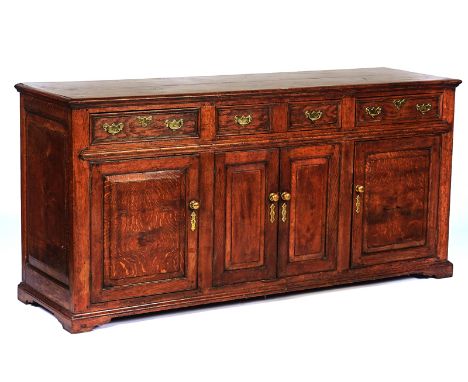 AN 18TH CENTURY STYLE OAK DRESSER BASEIncorporating earlier timbers, with three drawers over cupboards, 191cm wide; 92cm high