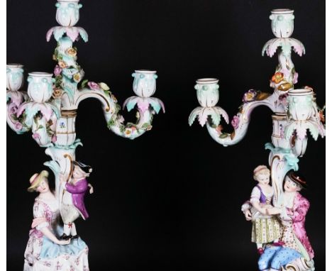 A MATCHED PAIR OF MEISSEN FOUR-LIGHT CANDELABRALate 19th centuryModelled as a seated man and woman supporting a standing boy 