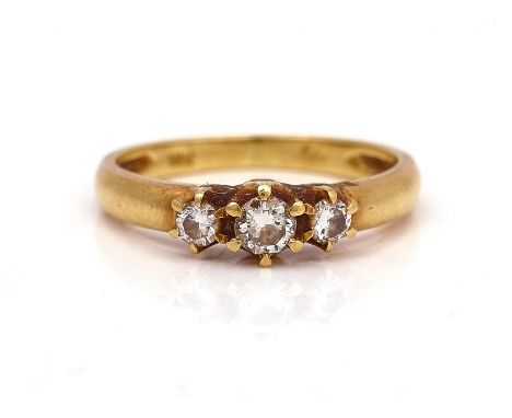 A GOLD AND DIAMOND THREE STONE RINGClaw set with a row of circular cut diamonds and with the principal diamond mounted to the