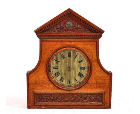 A 19TH CENTURY ARCHITECTURAL ELEMENTPossibly from a bookcase, with carved upper and lower frieze, centred by a brass clock fa