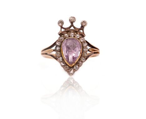 A VICTORIAN GOLD AND SILVER SET PINK TOPAZ &amp; DIAMOND RINGMounted with a foil backed pink topaz to the centre, within a ro