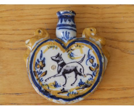 An antique delft flask painted in blue & ochre with a dog to one side and rabbits to the other, 5”