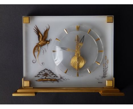 A 20thC Jaeger Lecoultre 'Marina' mantel clock in bird of paradise pattern, 7.75” across – dial facing rubbed.
