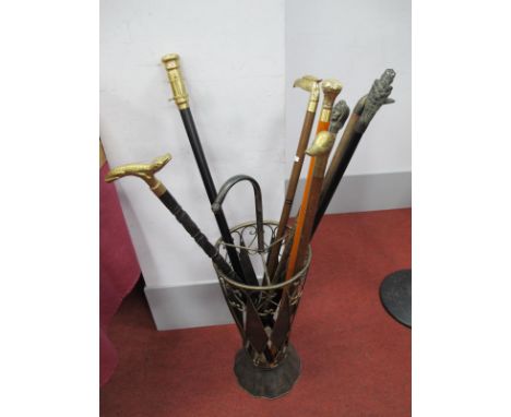 Walking Sticks in Umbrella Style Stick Stand, comprising of eight sticks, one with inset telescope, four with brass birds hea