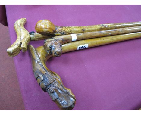 XIX Century Walking Stick, with carved dog's head; together with three other walking sticks, on carved a a horse's head. (4)