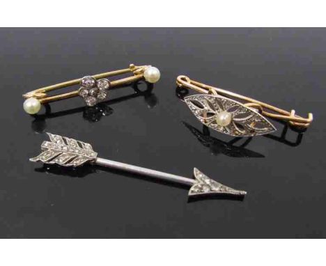A diamond set "arrow" tie pin, 3.8cm long, 1.8g unmarked with two diamond and pearl bar brooches, one as a pansy, unmarked, 2