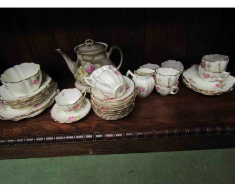 A Melba white ground tea set with pink floral design and a Crownford floral design teapot on stand 