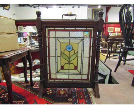 A mahogany fire screen with lead and glass floral panel, turned spindles, 81cm x 60cm