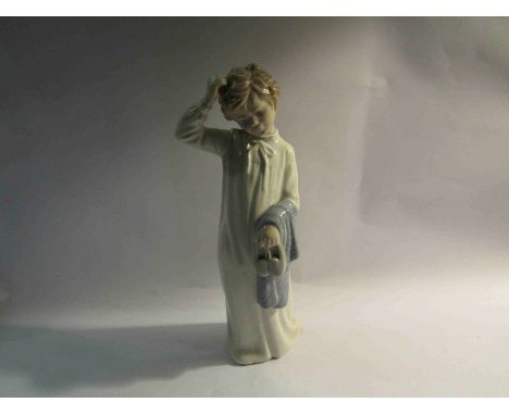 A Nao figure of boy in nightgown with slippers, 28cm tall