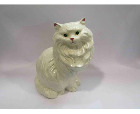 A large ceramic cat and four smaller figures, 37cm tallest