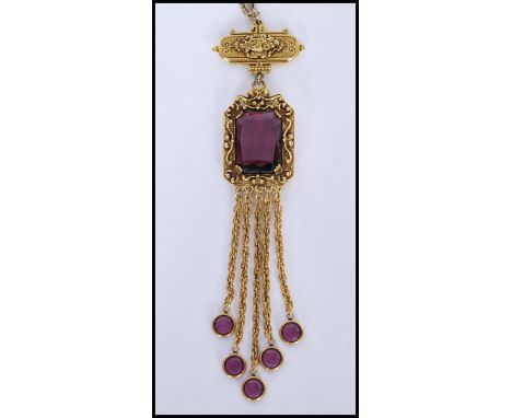 A vintage signed gold-tone drop necklace with large faceted purple glass stone with purple finial tassels. Signed Goldette. C