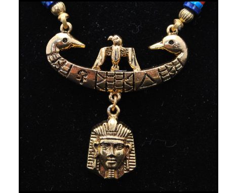 A vintage signed Art © Arthur Pepper gold-tone Egyptian revival pendant necklace. Measures 20 inches plus 11 1/2 drop.