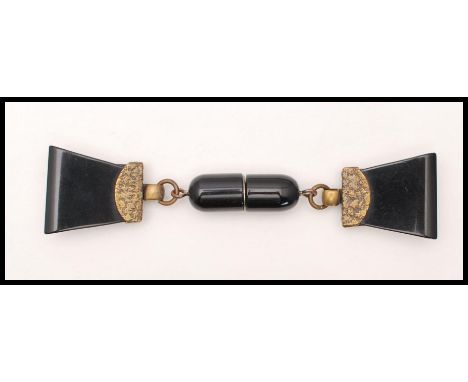 A 1930's Art Deco bakelite cloak / coat / sweater clip fastener having a screw clasp with embellished metal fittings and geom