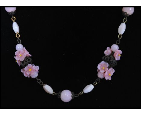 A 1920's vintage Czech pink glass bead flower necklace strung with pink lamp work flowers and satin glass beads interspaced w