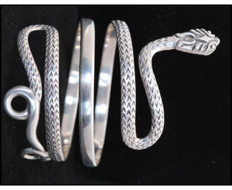 A vintage 925 silver bangle in the form of a coiled snake. Weight 76g. Total width 4 inches.