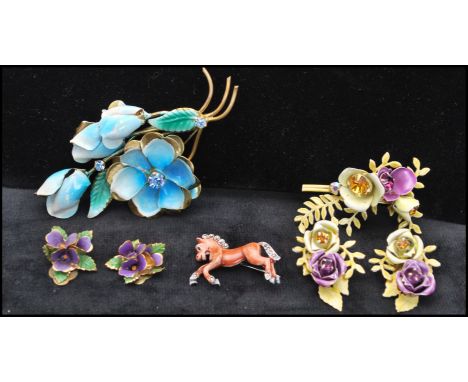 A collection of 1950s enamel jewellery to include violet earrings marked Austria, a large floral spray brooch, a brooch and e