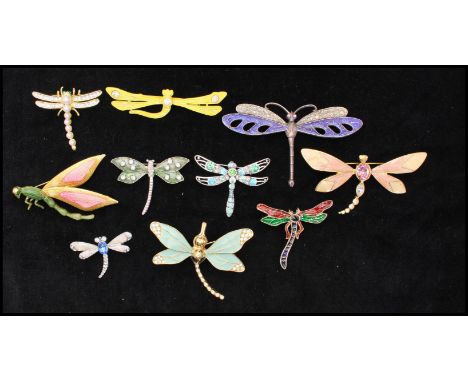 A collection of vintage dragonfly bug brooch pins to including rhinestone set, faux pearl, enamel, decorated styles. To inclu
