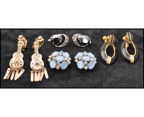 A collection of vintage clip on earrings some signed to include celluloid paste set guitars, satin glass and rhinestone signe