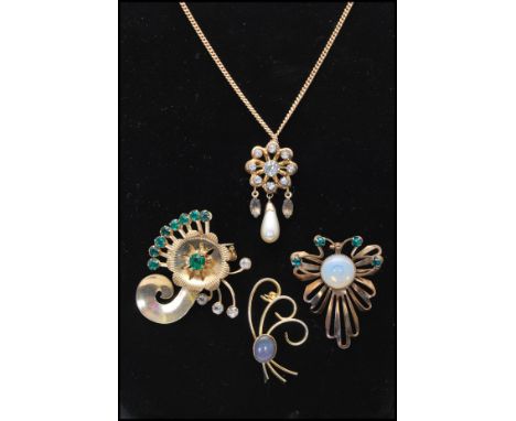 A 1930's signed gold filled pendant brooch pin on chain set with white rhinestones having smokey rhinestone drops and a pearl