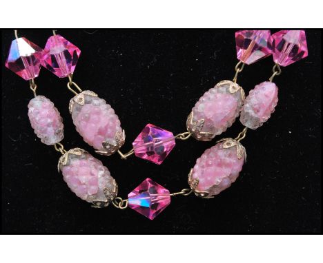 A vintage signed Trifari art glass pink sugar givre bumpy bead and crystal triple strand necklace. Longest chain measures app