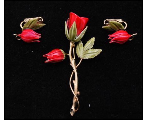 A 1950's gold tone enamel brooch and earring set in the form of tulips. Measures approx 3 inches.