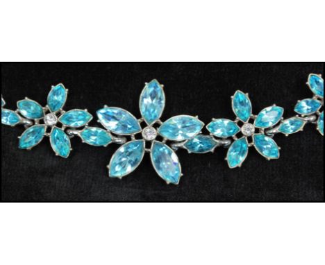 A vintage signed rhinestone set necklace having large aqua blue rhinestone flowers with rhinestone set foliate style chain an