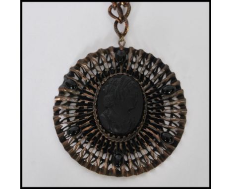 A vintage Victorian revival&nbsp; oversized pendant necklace having a central jet black glass cameo surrounded by a star ruff
