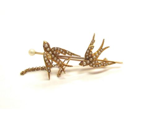 An unmarked gold brooch as two seed pearl set swallows, with safety chain, 5.5cm long, 6.3g 