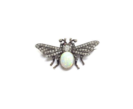 An Edwardian brooch as a Bee, the ruby eyes on a diamond set thorax and oval opal abdomen, the wings encrusted with old cut d